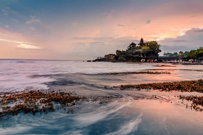 Tanah Lot là một ngôi đền Hindu linh thiêng nằm ngay trên đỉnh của một khối san hô khổng lồ nhô ra khỏi đại dương. Mặc dù chỉ những người hành hương mới có thể tiếp cận bên trong ngôi đền, nhưng khung cảnh hoàng hôn tuyệt đẹp đã khiến ngôi đền này trở thành một địa điểm nhất định phải đến ở Indonesia.
