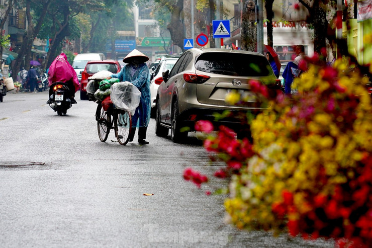 Đội nón, mặc chiếc áo mưa mỏng, người lao động lại tiếp tục rong ruổi khắp ngõ ngách đường phố để mưu sinh.