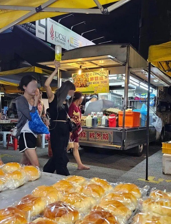 Cô gái đang truyền dịch vẫn ra chợ đêm ăn vặt, còn có người bạn cầm chai dịch đi cùng - 2