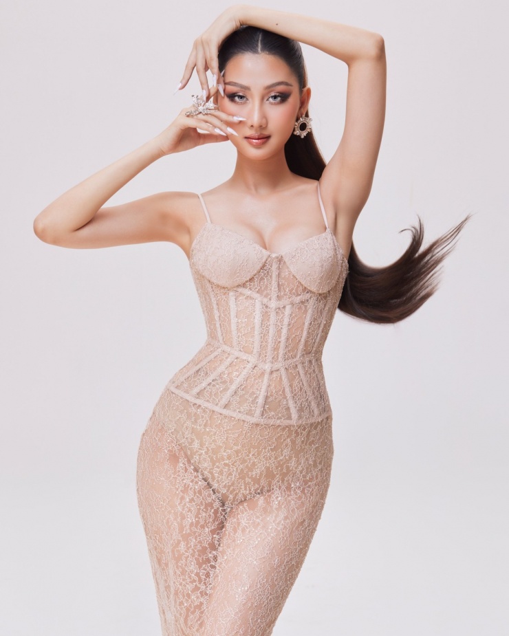 Để đi cùng đầm ren, hoa hậu sử dụng bodysuit màu da. Dưới ánh đèn mạnh, bộ đầm phản chiếu trông mỏng hơn.