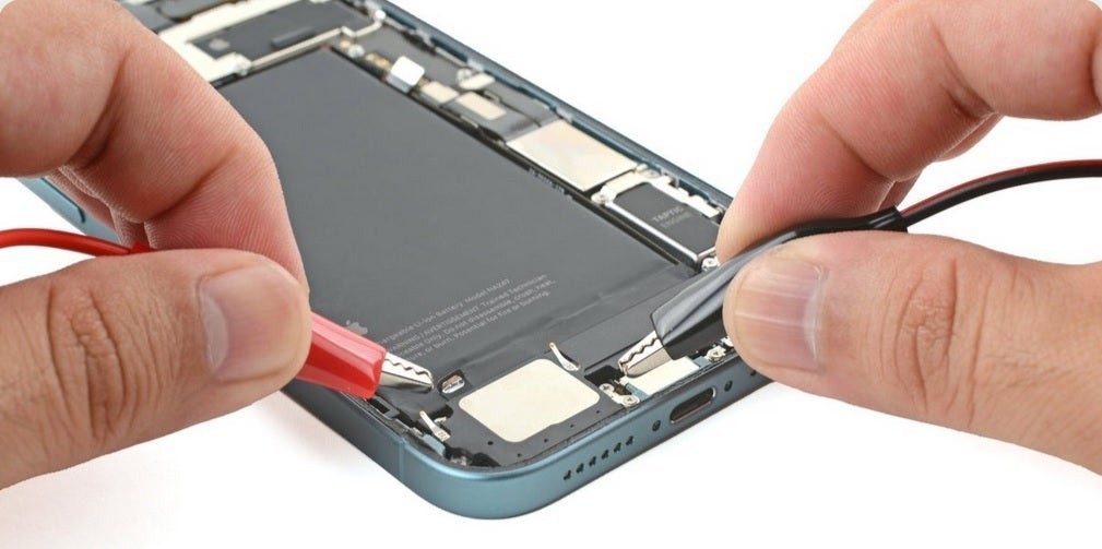 The electric current will weaken the adhesive, allowing the battery to be removed from the phone without much force.